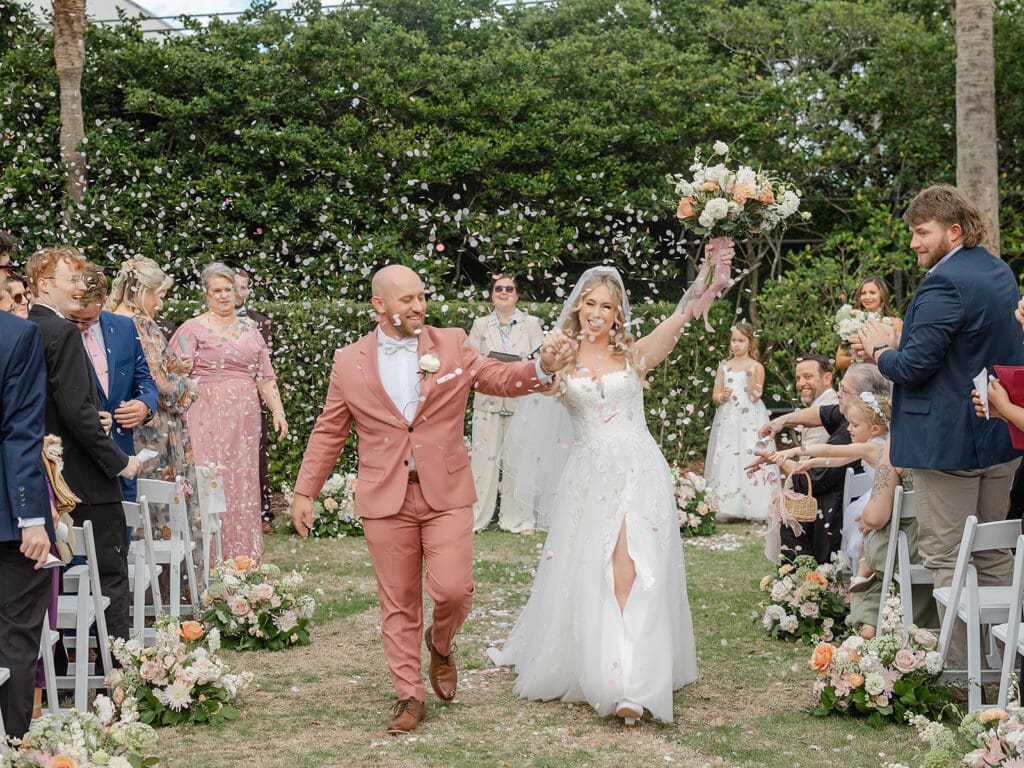Bride and groom walking down the aisle after ceremony during wedding in Brunswick, Georgia
